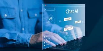 Hand typing. the screen displaying "Chat AI"