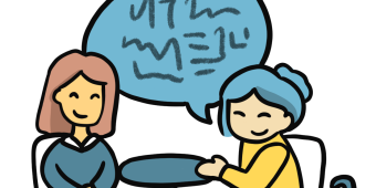 two girls sitting at the table chatting